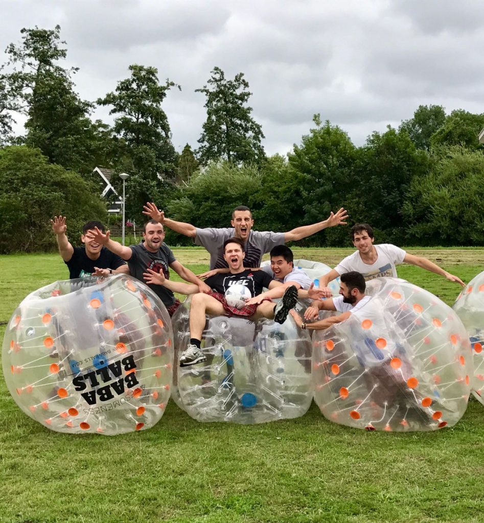 Group of people playing bubble football.