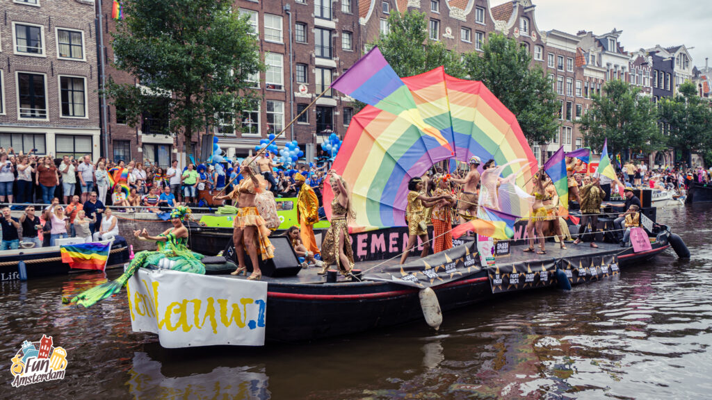 People dancing on the canal parade during gay pride Amsterdam