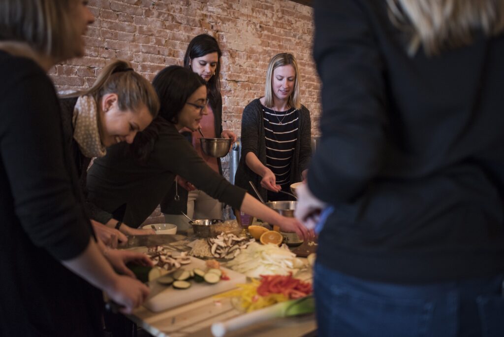 Ladies during a cooking workshop Amsterdam.
